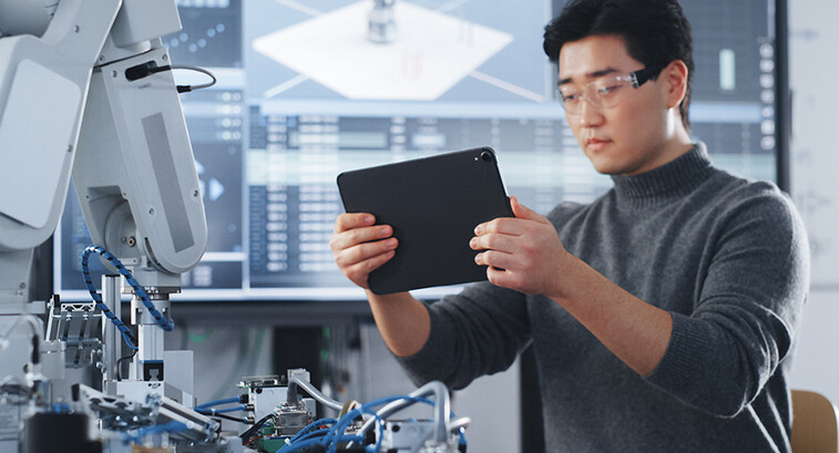 Student Holding Tablet and Controlling Robot Hand Moving at Different Ways At University Class