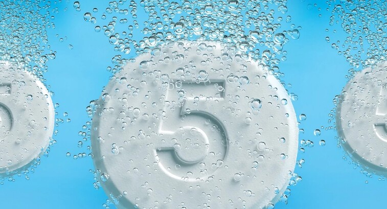 Tablets with the number five on them dropping into liquid and fizzing