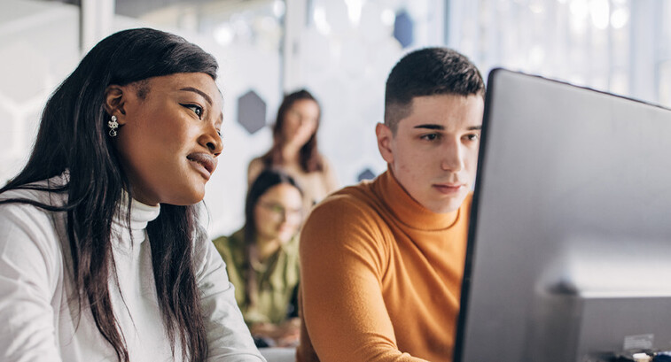 Students looking at computer
