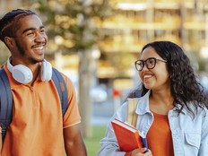 Two college students chat on an outdoor walk