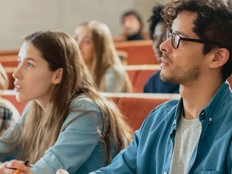 Students in a lecture hall listen intently