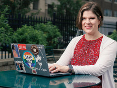 Patricia Clay uses her desktop at an outdoor table
