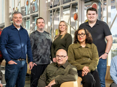 A team of IT employees at the Universities of Wisconsin pose for a photo.