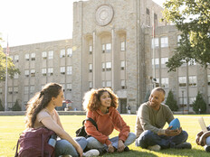 Students sitting on the campus grounds