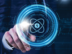 Person pressing illustrated atom