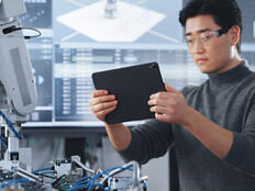 Student Holding Tablet and Controlling Robot Hand Moving at Different Ways At University Class