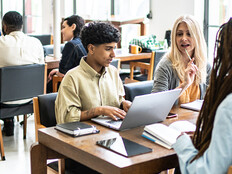 Students working at tables together
