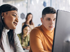 Students looking at computer