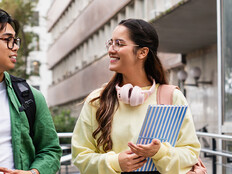 Student friends walking with books