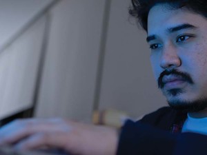 A person works on their laptop