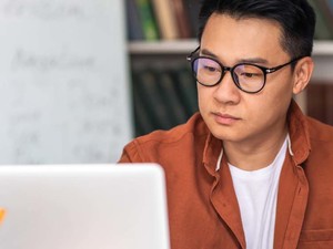 A man works on a laptop