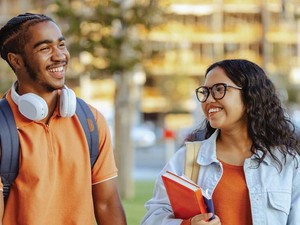 Two college students chat on an outdoor walk