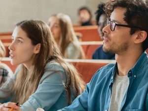 Students in a lecture hall listen intently