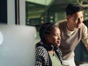 Professor helping student in computer lab