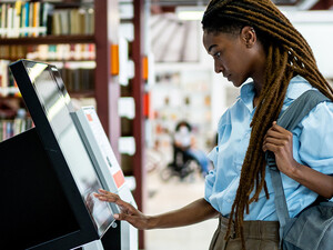 Student searching for a book in the library system