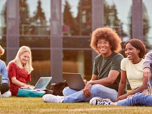 Students using device on quad