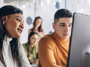 Students looking at computer
