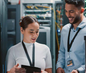 two colleagues working together in a server room