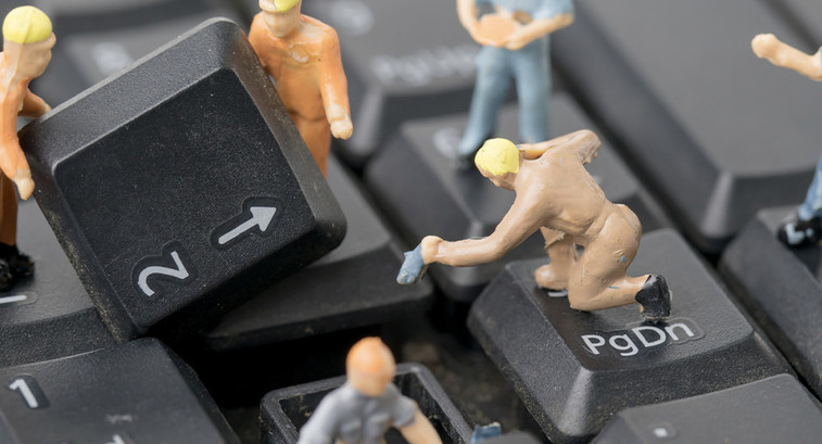 Miniature figurines work on computer keyboard