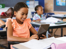 K–12 Student Using Integrated Tablet Technology in the Classroom