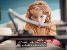 K–12 student watching 3D printer