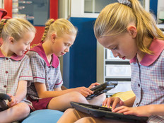 Students in a classroom using tablets