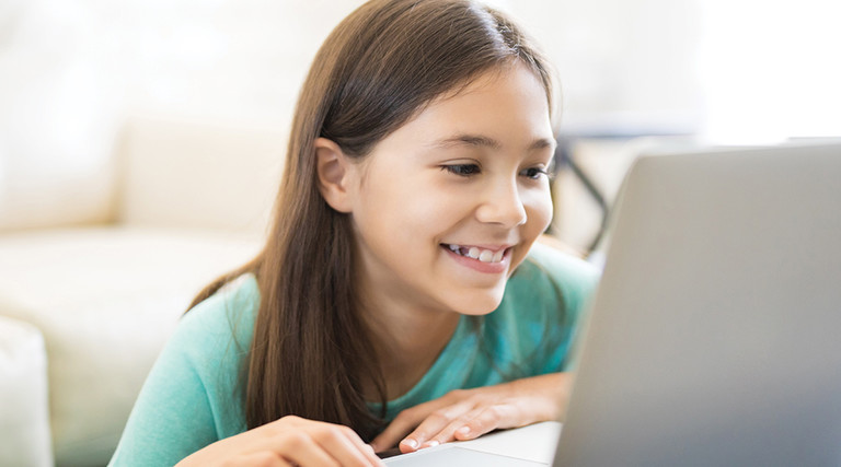 young girl on laptop smiling 