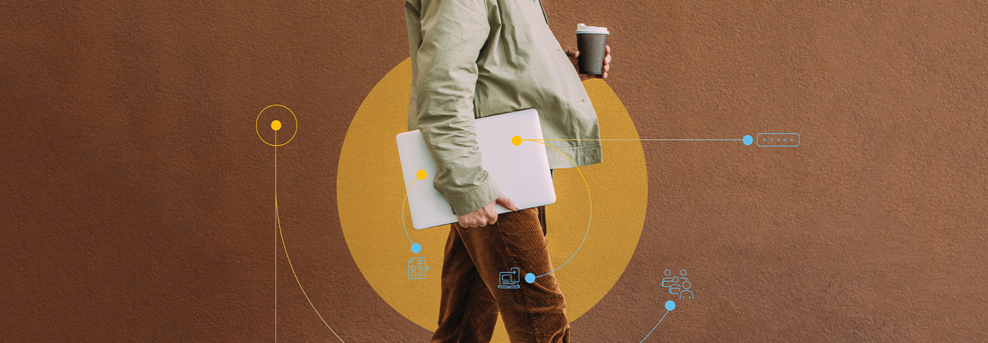 Person walking with laptop under arm and coffee cup in hand