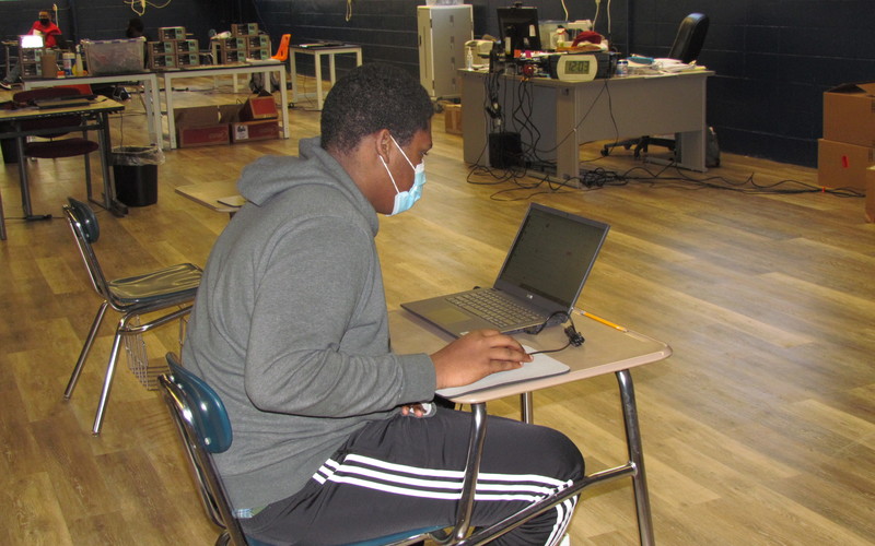 A JROTC Cadet at his laptop