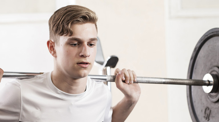 young man with a barbell