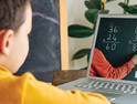 boy learns math through video call on computer 