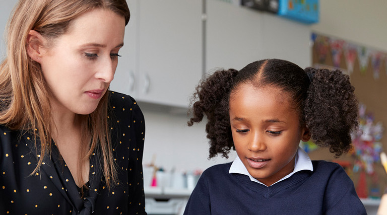 Teacher working closely with student