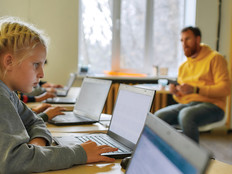 Students on laptops in classroom