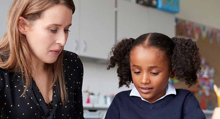 Teacher working closely with student