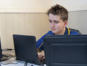 teenage boy using computer at home