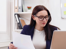 Admin auditing at laptop in office