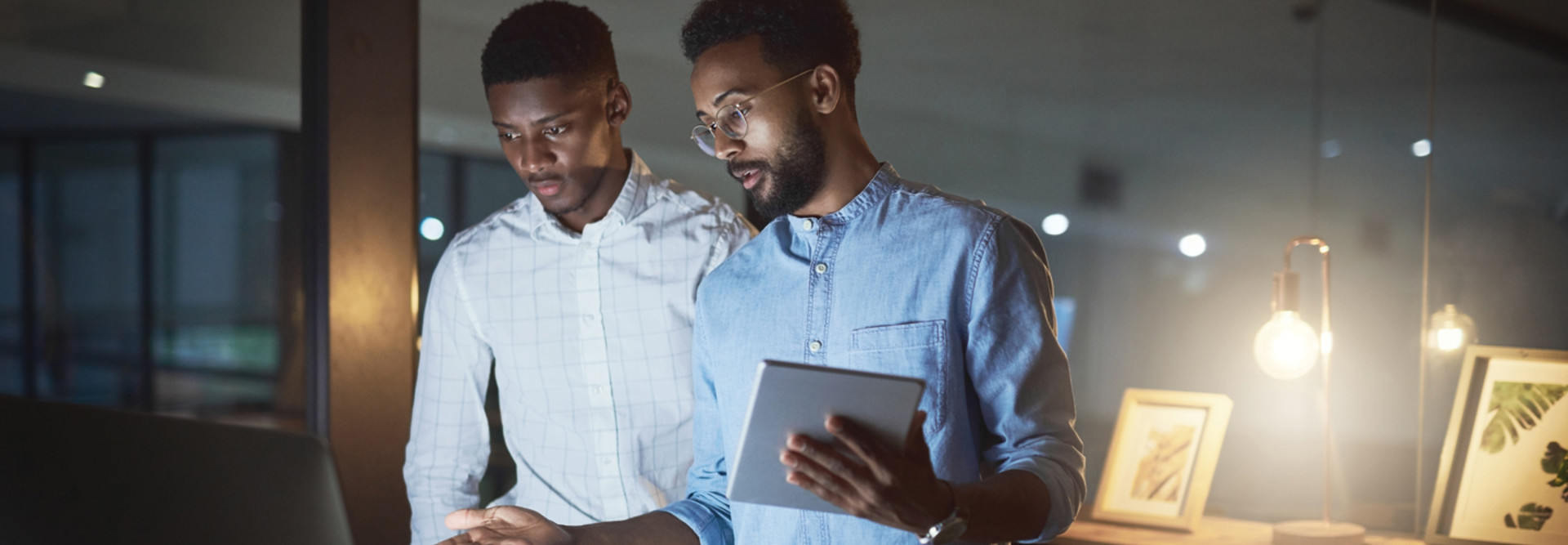 Two men with tablet and desktop computer looking at cybersecurity awareness