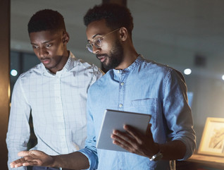 Two men with tablet and desktop computer looking at cybersecurity awareness