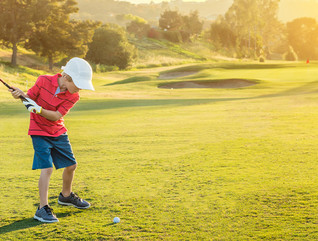 Boy golfing