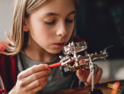 girl tinkering with robot