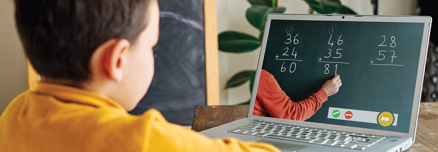 boy learns math through video call on computer 
