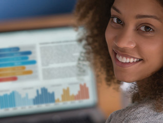 woman looking at data on a laptop