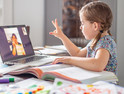 little girl learns from home while teacher teaches remotely