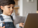 young boy looking at laptop screen for e-learning