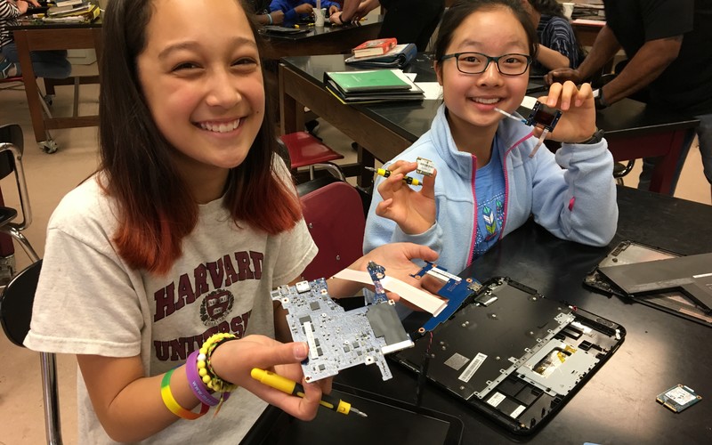 students holding computer parts
