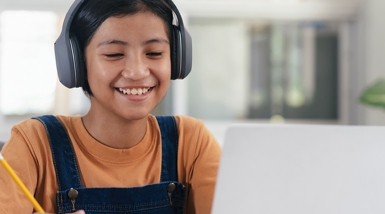 Student on laptop with headphones 