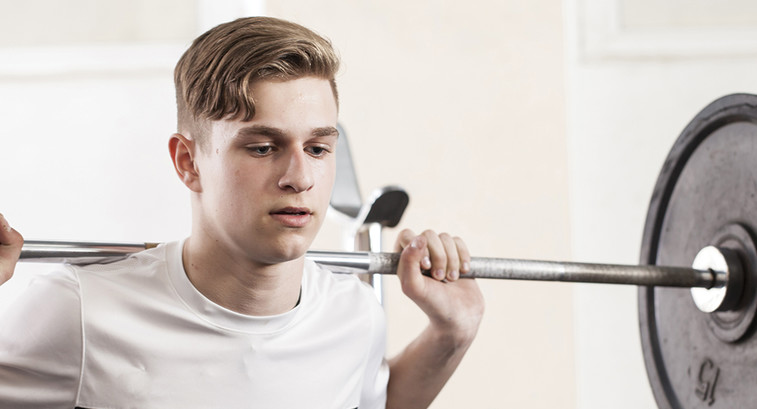 young man with a barbell