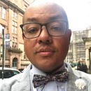 Headshot of Dave Robles wearing glasses and bowtie