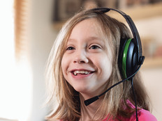 young girl smiling with gaming headset on 