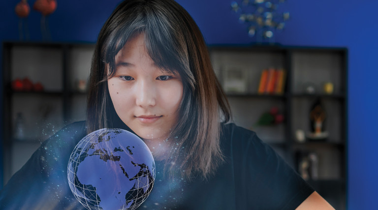 World language student uses technology to view a holographic projection of globe